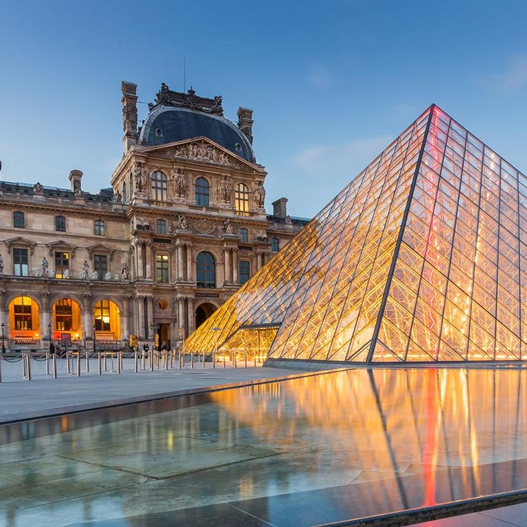 The Louvre pyramid in Paris, illuminated at night